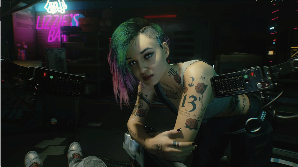 Judy Alvarez, a woman with dyed hair and tattoos, stares at the camera.