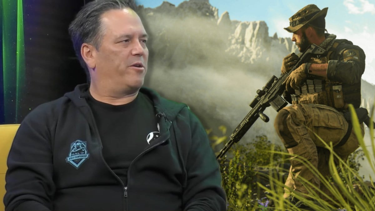 Phil Spencer sitting in a chair next to a Call of Duty character.