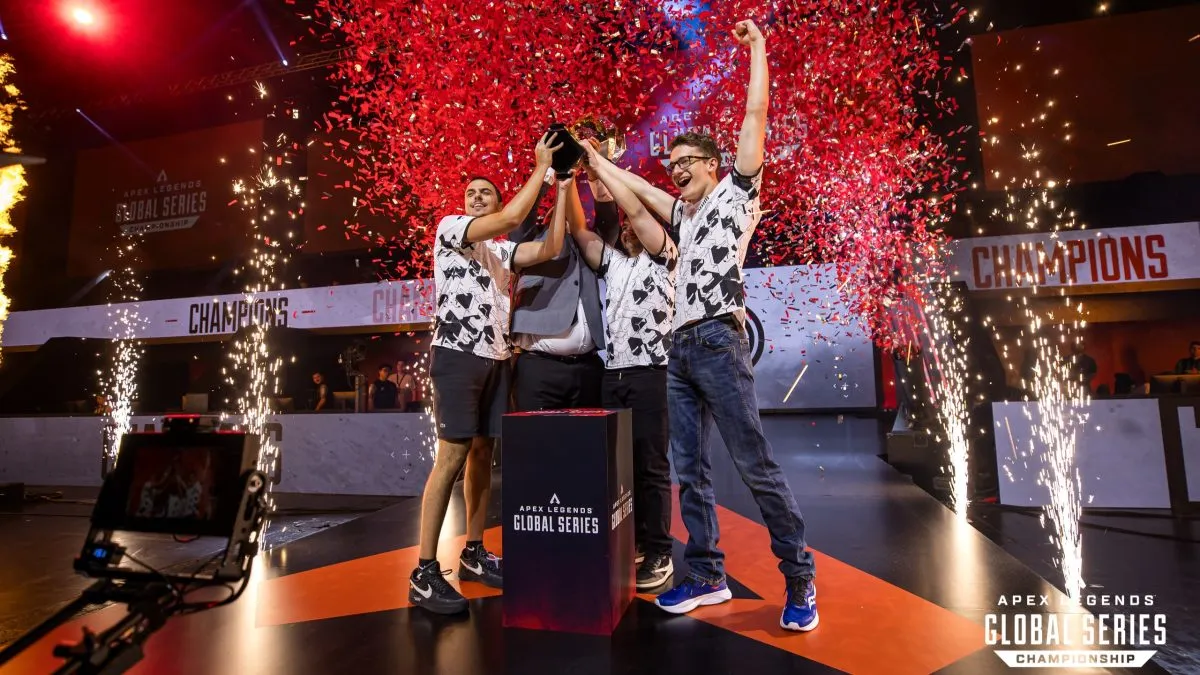 TSM Apex lifts the ALGS Championship trophy as ref confetti and sparklers go off in the background.