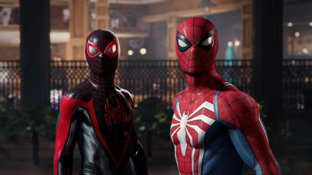 Miles Morales and Peter Parker stand together in their Spider-Man suits.