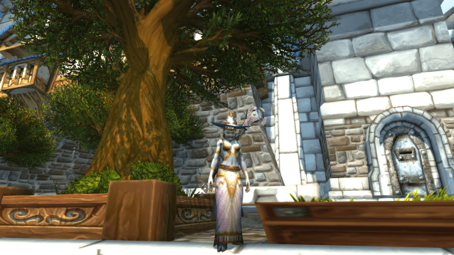 A Lightforged Draenei stands in Stormwind City in WoW wearing the Vicious Embersilk Cowl