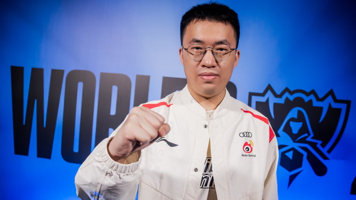 Xiaohu posing in front of a camera with his fist closed.
