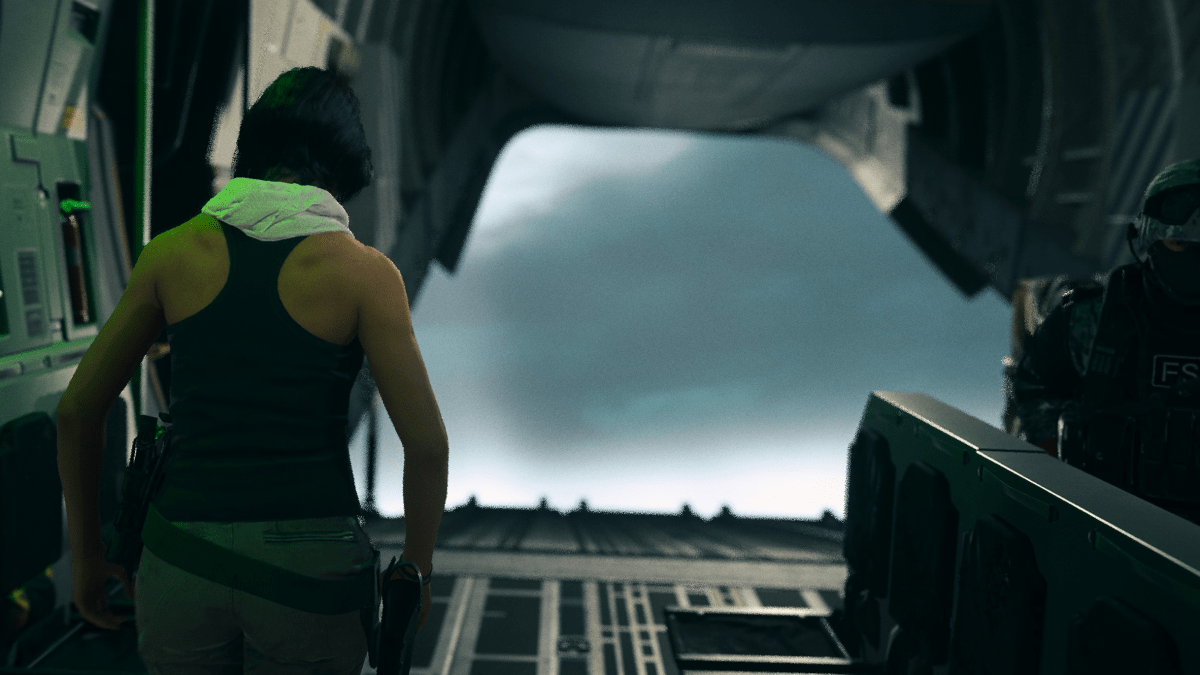 An operator looks out the open cargo door of a plane into a sea of fog.