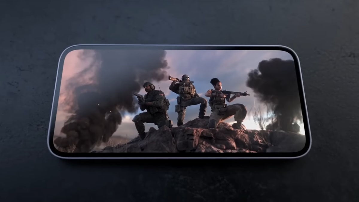 Call of Duty: Warzone Mobile, displayed on a smartphone sitting on a table.