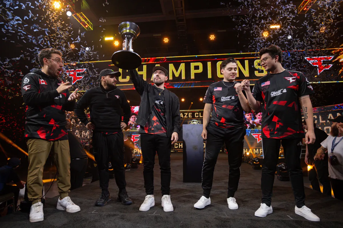 The members of FaZe's Halo Infinite team hold up the championship trophy on the main stage.