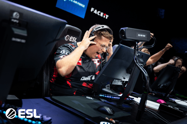 Karrigan, in-game leader for FaZe, cheers and takes his headphones off after a win at IEM Sydney.
