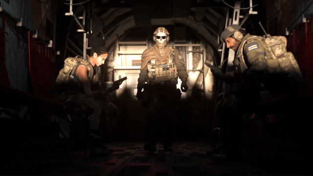 A soldier in a skull mask walks toward a ramp of a cargo plane with two squadmates sitting, preparing their weapons, in Call of Duty: Warzone Mobile.