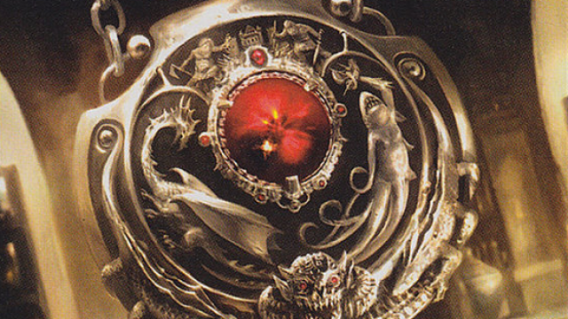 A silver amulet with multiple rivets and a red center sits on a table in MtG.