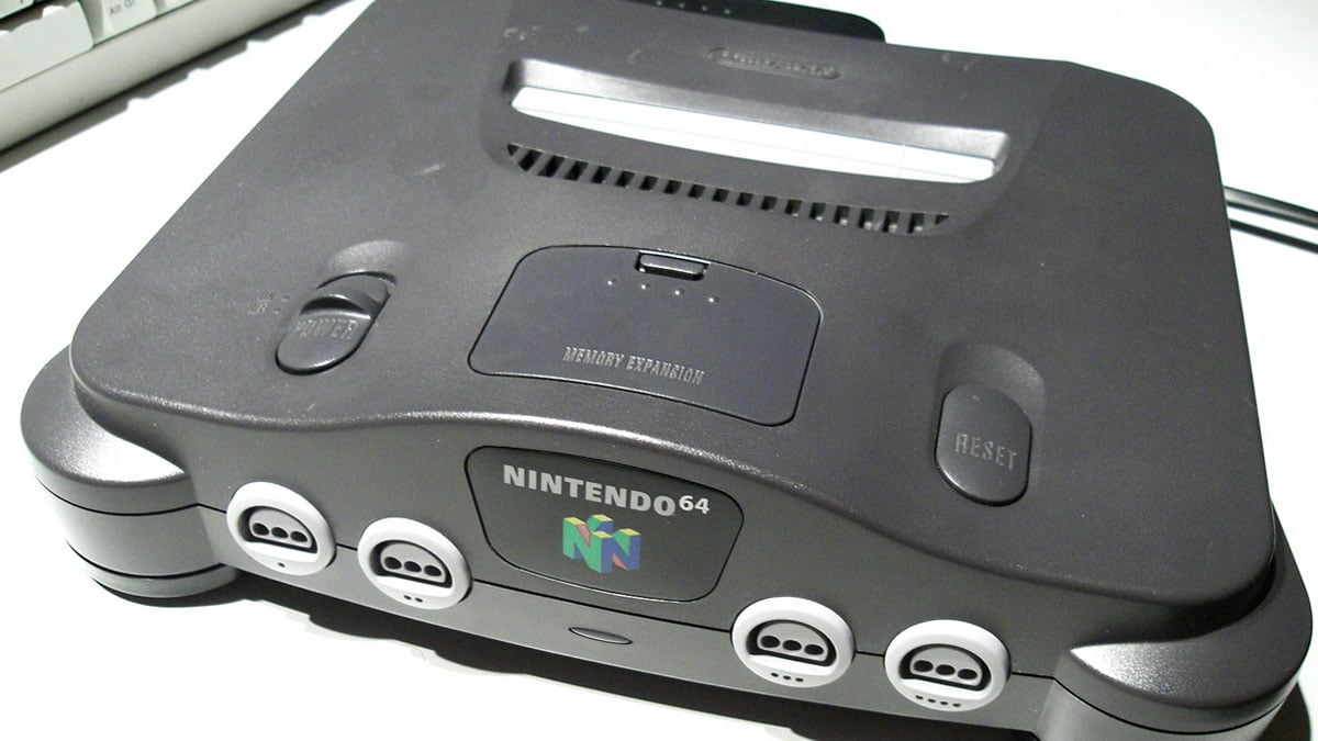 A Nintendo 64 classic console sitting on a table next to a keyboard.