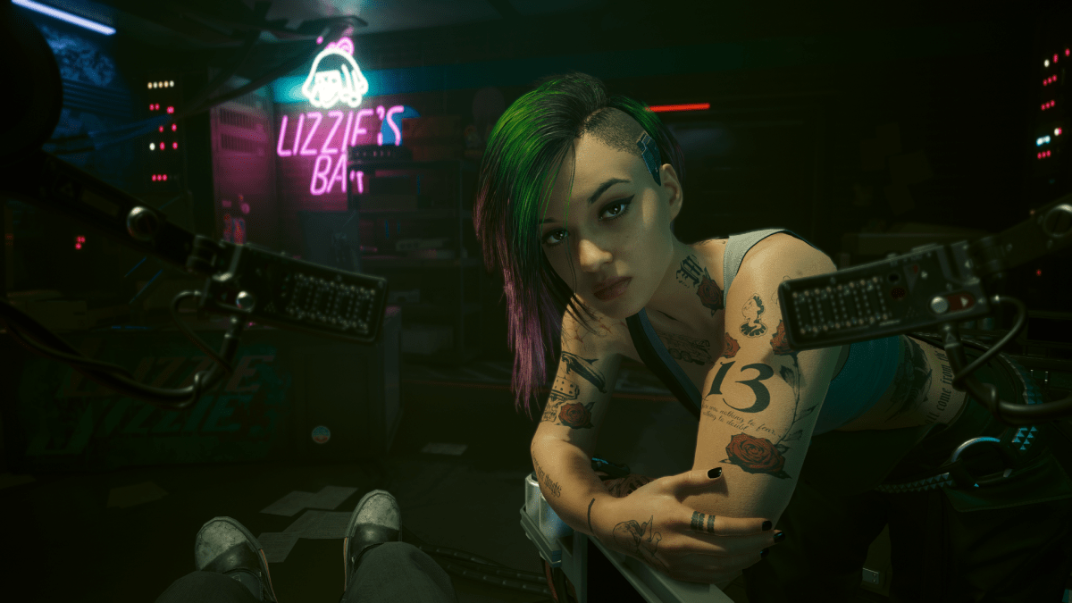 Judy Alvarez, a punk woman with overalls, tattoos, and green hair from Cyberpunk 2077