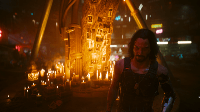 Johnny standing in front of a memorial tree with beautiful, warm candle light (Cyberpunk 2077).