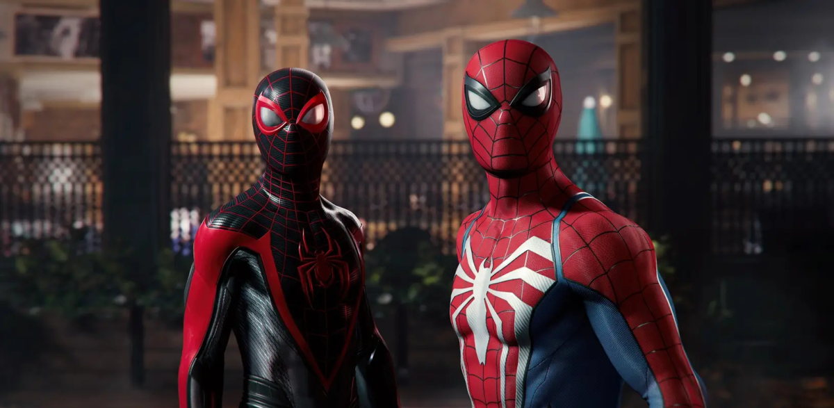 Miles Morales and Peter Parker stand together in their Spider-Man suits.