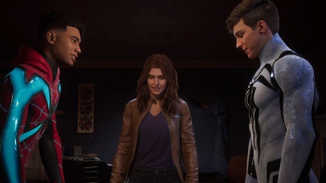 Miles Morales, Mary Jane Watson, and Peter Parker stand together around a table, looking down.