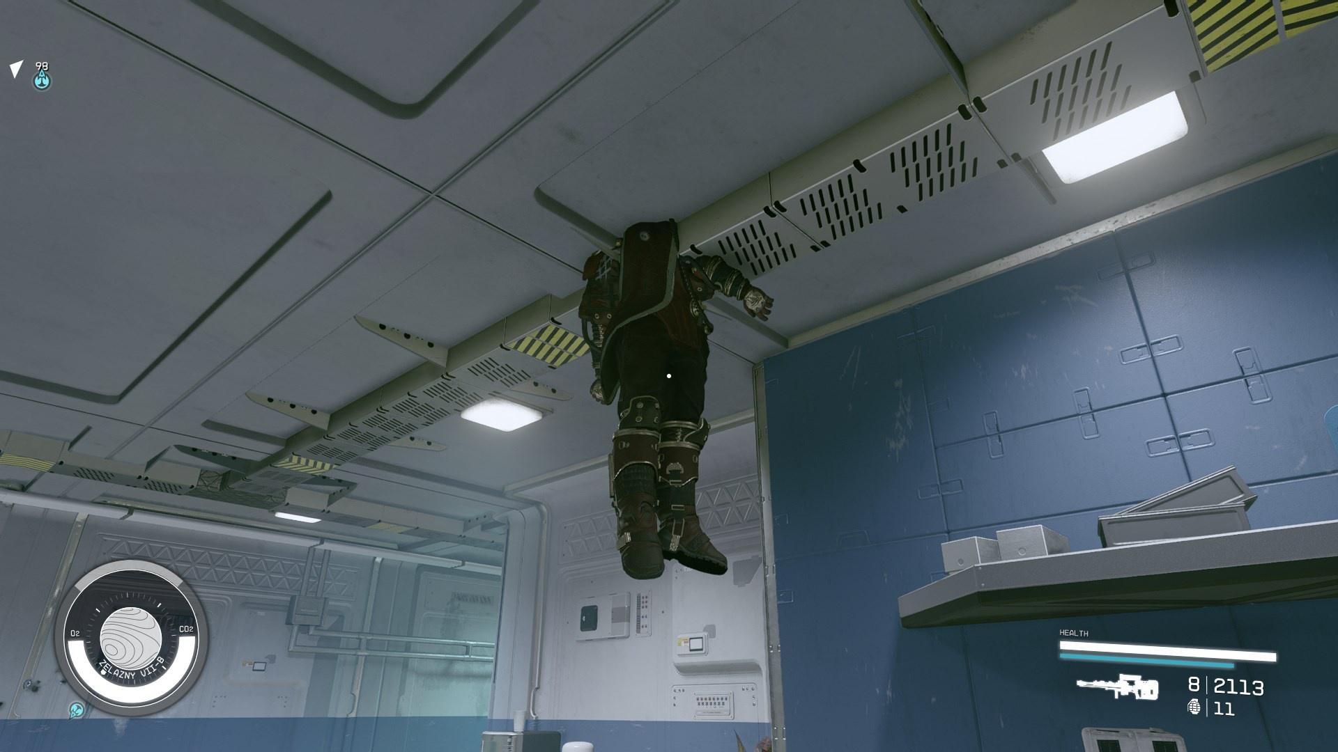 image displays a dead space pirate that has glitched into the ceiling of a spaceship so that his body is hanging down in mid air (Starfield).