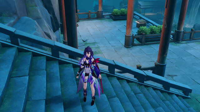 Seele standing on some stairs with a chest in the background.