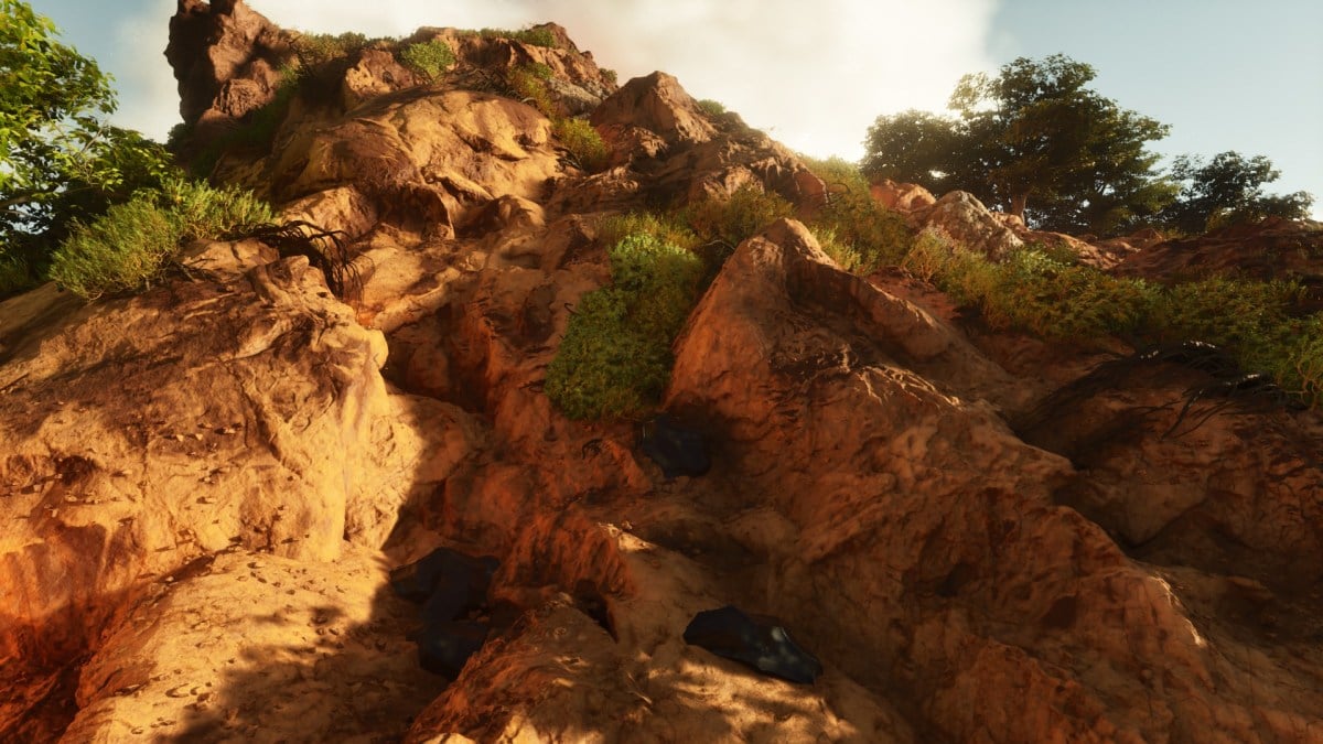 Obsidian rocks shown on the side of a mountain in Ark: Survival Ascended.