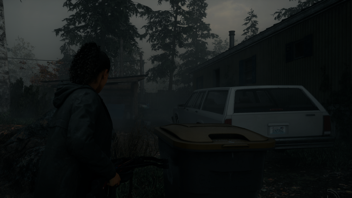 Saga approaching a white car parked next to a trailer park on a gloomy day in the forest (Alan Wake 2).