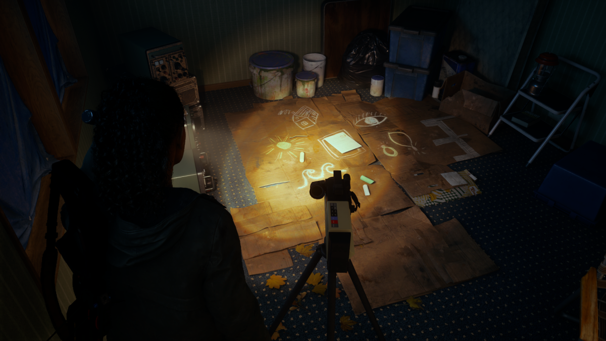 Saga pointing her flashlight at a Nursery Rhyme on the bedroom floor of a trailer in Alan Wake 2.