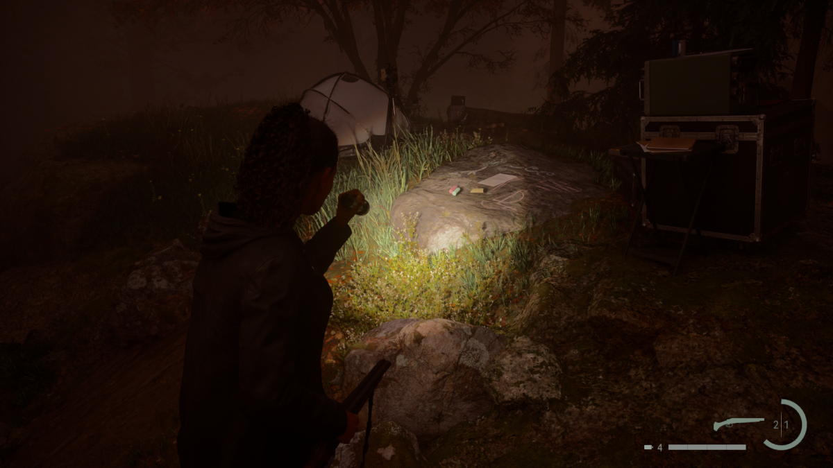 Saga's flashlight illuminating a Nursery Rhyme on the forest floor at night in Alan Wake 2.
