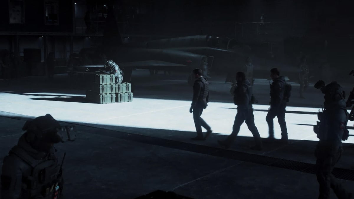 Soldiers walk toward a box in a hangar in Call of Duty.