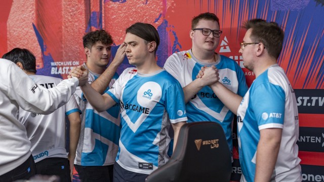 Photo taken of Cloud9's CS2 team during BLAST Premier Fall Final 2023. The players are all wearing Cloud9's white and blue jersey and giving hand shakes.