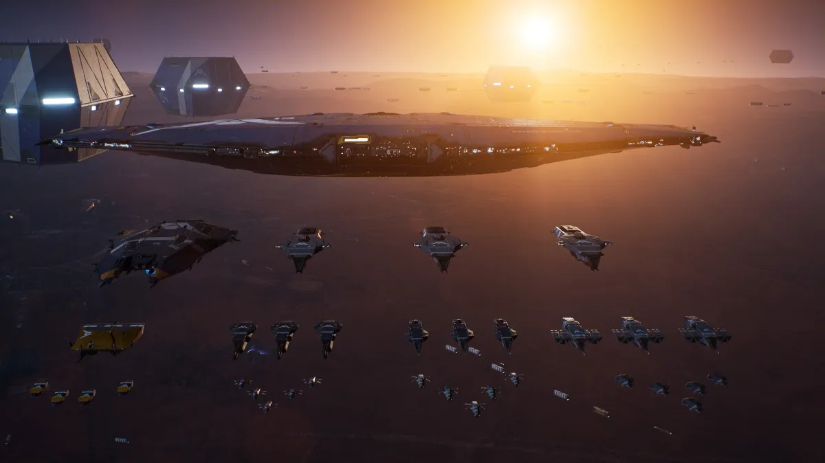 The image shows a big air ship and a bunch of smaller air ships at sunset.