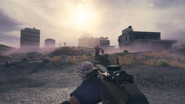 Image from MW3 Zombies taken on the beach with zombies flooding toward the player. There is a cloudy but misty sky in the background and a weapon on the screen.