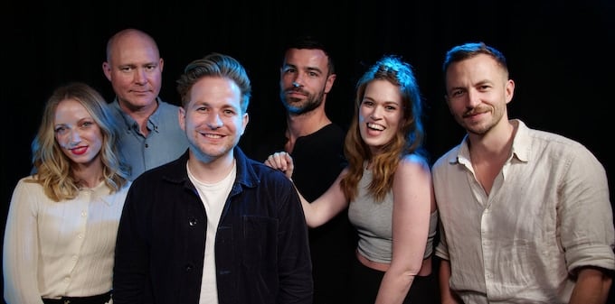 The Natural Six cast pose for a photo.