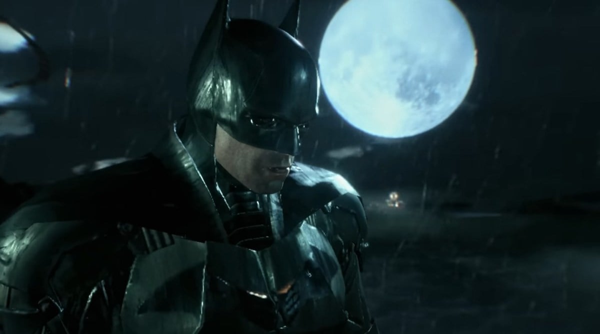 There is a shot of Batman standing on a building, with the moon in the sky behind him.
