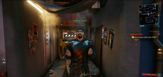Gary the Prophet stands by an alleyway with a mattress in it in Cyberpunk 2077.