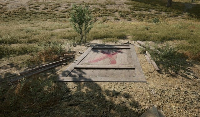 Secret Rooms in PUBG, a wooden door on the ground marked with a red X.
