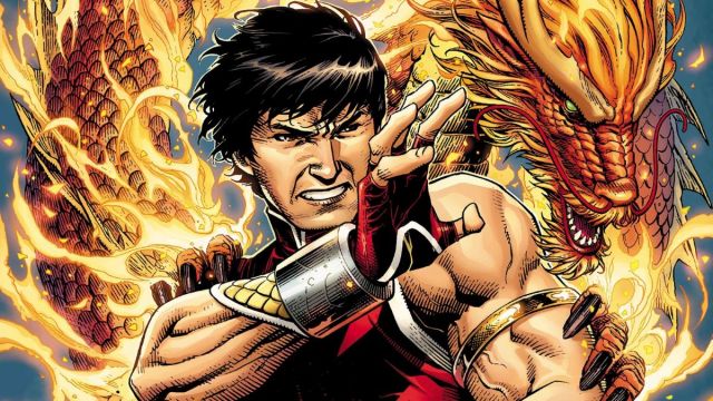 Shang-Chi in the comics, posing with his red costume in front of a dragon
