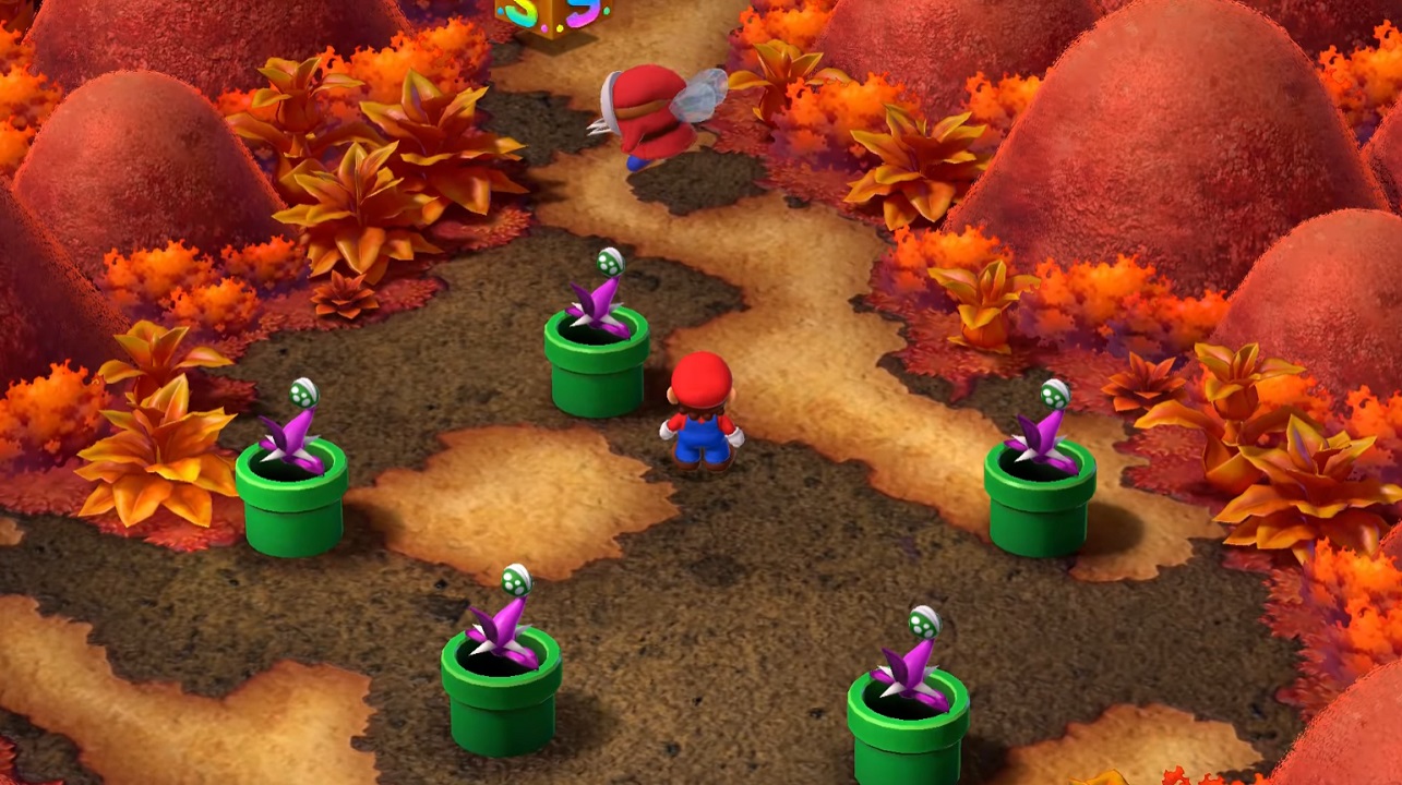 There is a shot of Mario in Bean Valley, surrounded by pipes with flowers sticking out. There is a Shy Guy flying around.