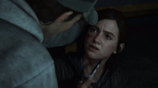 There is a shot of Ellie being held by someone with a knife to her throat.