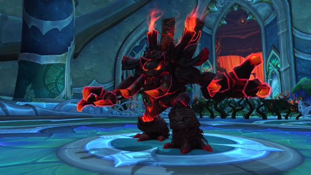Gnarlroot, the first boss of the new Amirdrassil raid in World of Warcraft Dragonflight, standing menacingly with his glowing red arms outstretched.