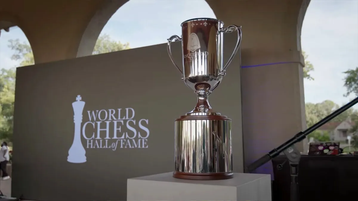 The Sinquefield Cup, a massive trophy, next to a Chess Hall of Fame banner at the St. Louis Chess Club.