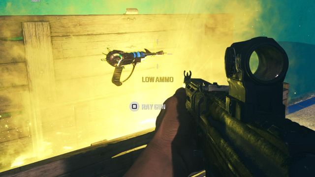 A Ray Gun rises out of a golden Mystery Box as a player watches on in MW3 Zombies.