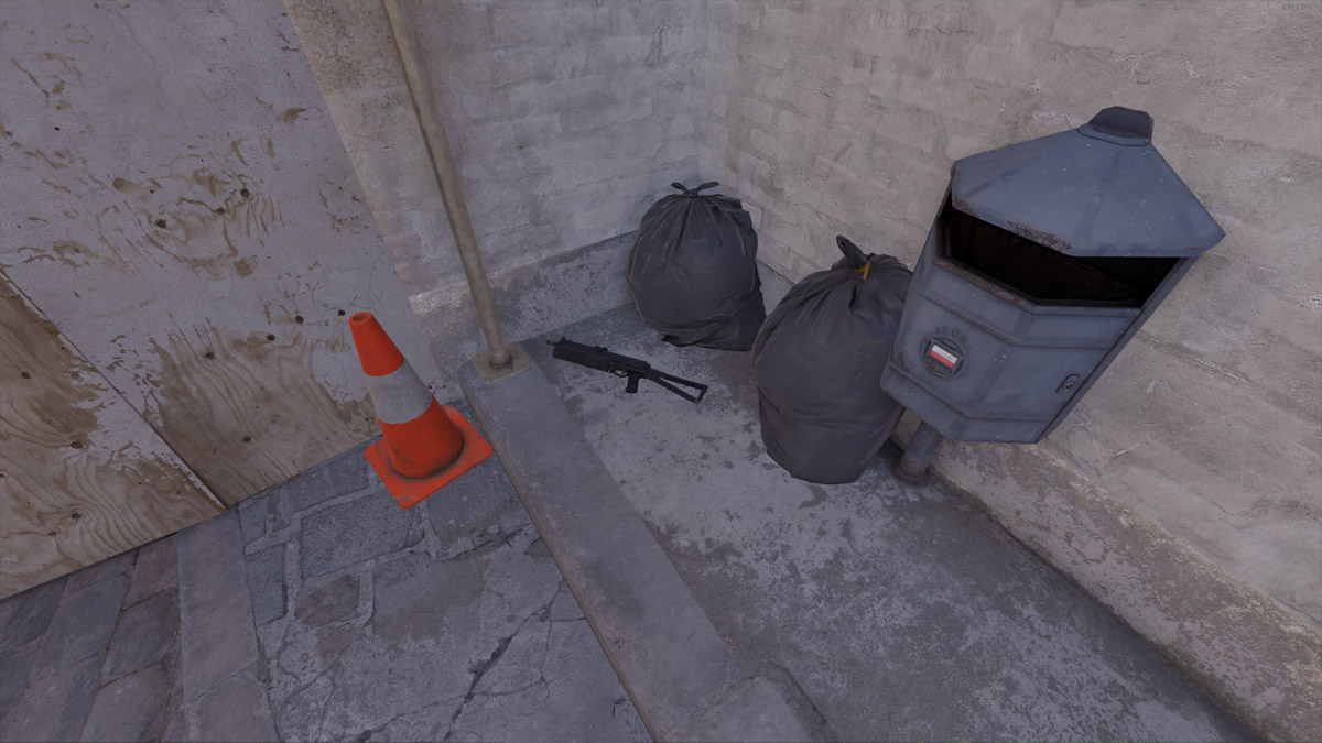 A PP-Bizon SMG from Counter-Strike 2 sits in front of two garbage bags on Inferno.