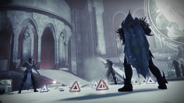 Three guardians stand in Riven's chamber, observing a pile of triangular motes sitting on the ground.