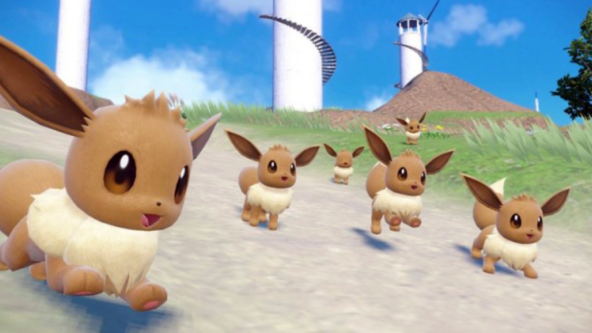 Four Eevees running around in the fields of Paldea.
