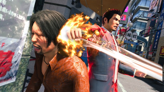 Kiryu slams his flaming fist into the side of a man's head.