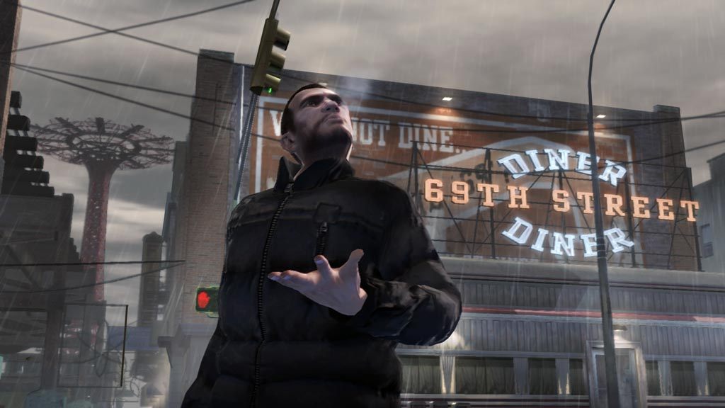 A screenshot of GTA4 character Niko Bellic standing outside in the rain.