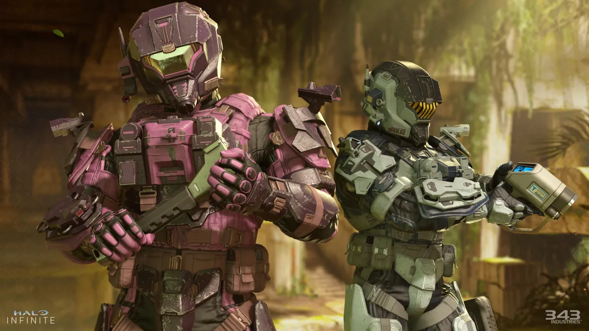 Two Spartans are standing on the map Forbidden. The one on the left is holding a wrench, while the one behind them to the right is holding a target locator.