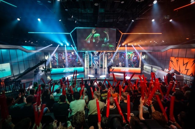 A crowd cheers at the LEC Championship as two League of Legends teams go head-to-head on stage.