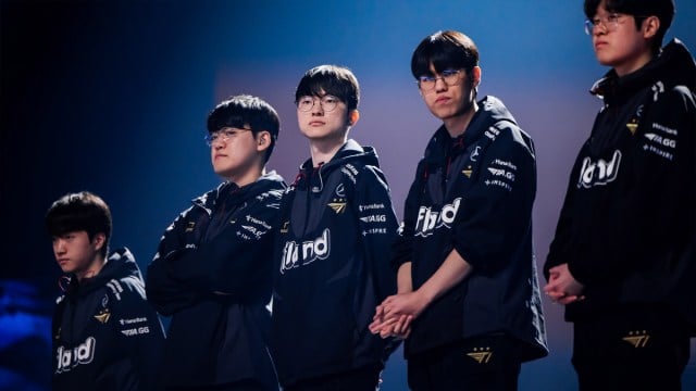 The T1 League of Legends squad standing in a line on stage at the World Championship finals in Seoul.