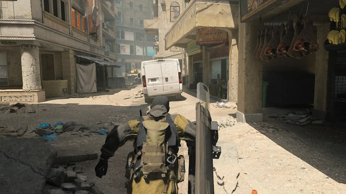 A player wields a riot shield in Modern Warfare 3, sprinting on Invasion.