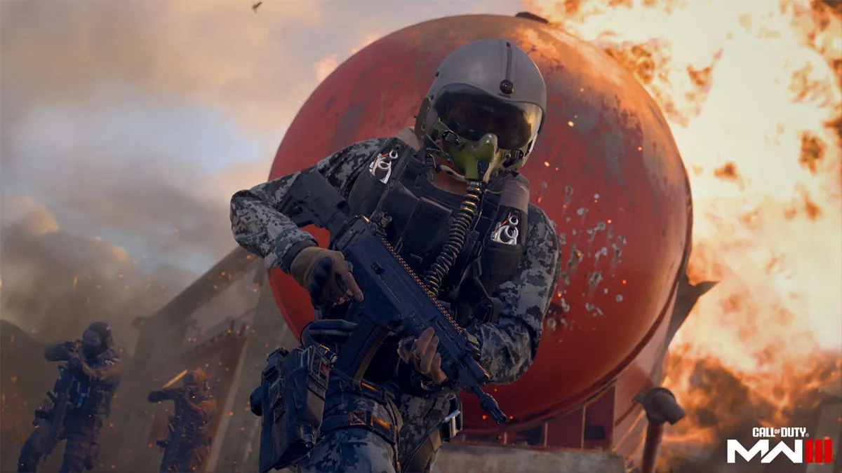 A soldier with a pilot's helmet runs with a weapon as a building explodes behind them in Modern Warfare 3.