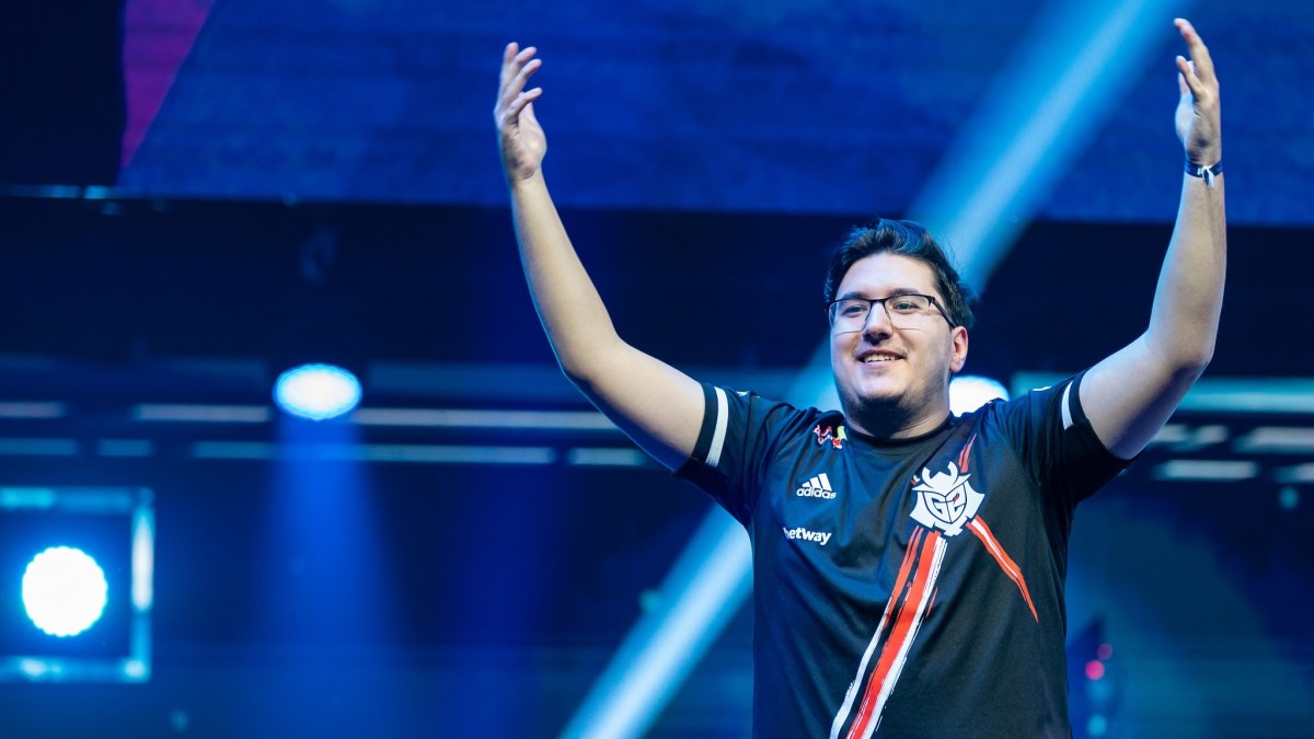 Nexa, CS2 player, raises his arms on stage. He's wearing a G2 jersey.