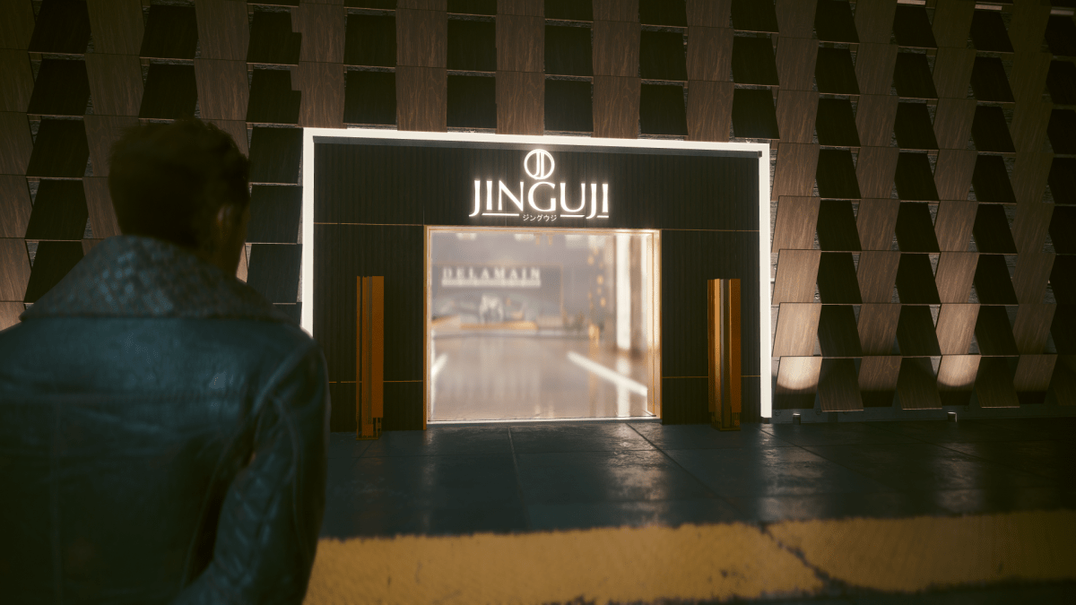 An over the shoulder shot of V standing on the sidewalk facing Jinguji clothing store in Cyberpunk 2077