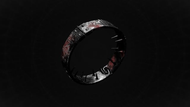 A strange gray ring with engravings sits on a black background in Remnant 2.